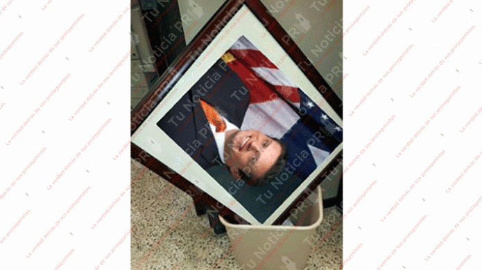 "Tiran al zafacón"foto del gobernador en una agencia Pública